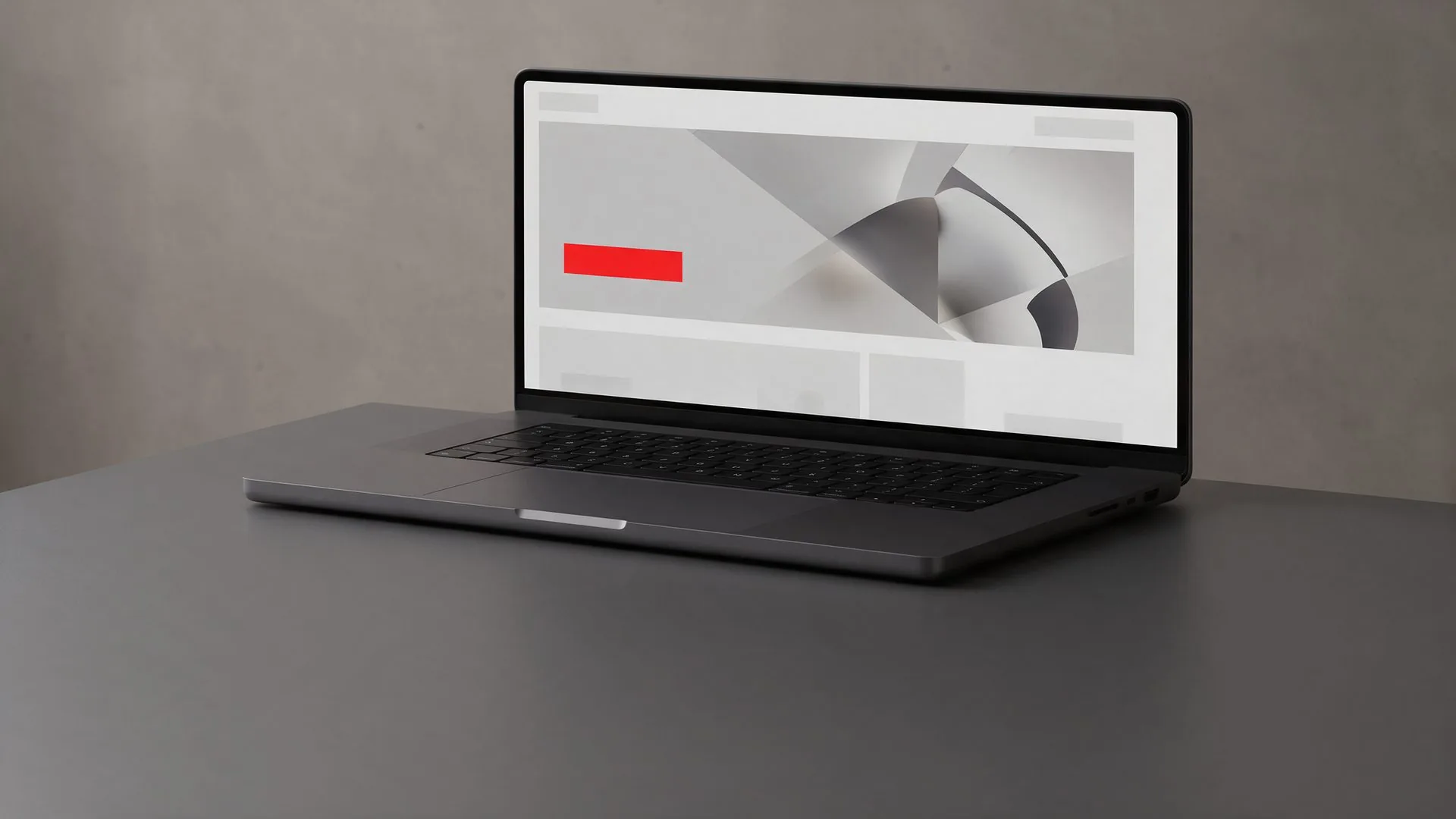 Diseño de páginas web en Monterrey: laptop sobre un escritorio gris mostrando una landing page con un botón rojo